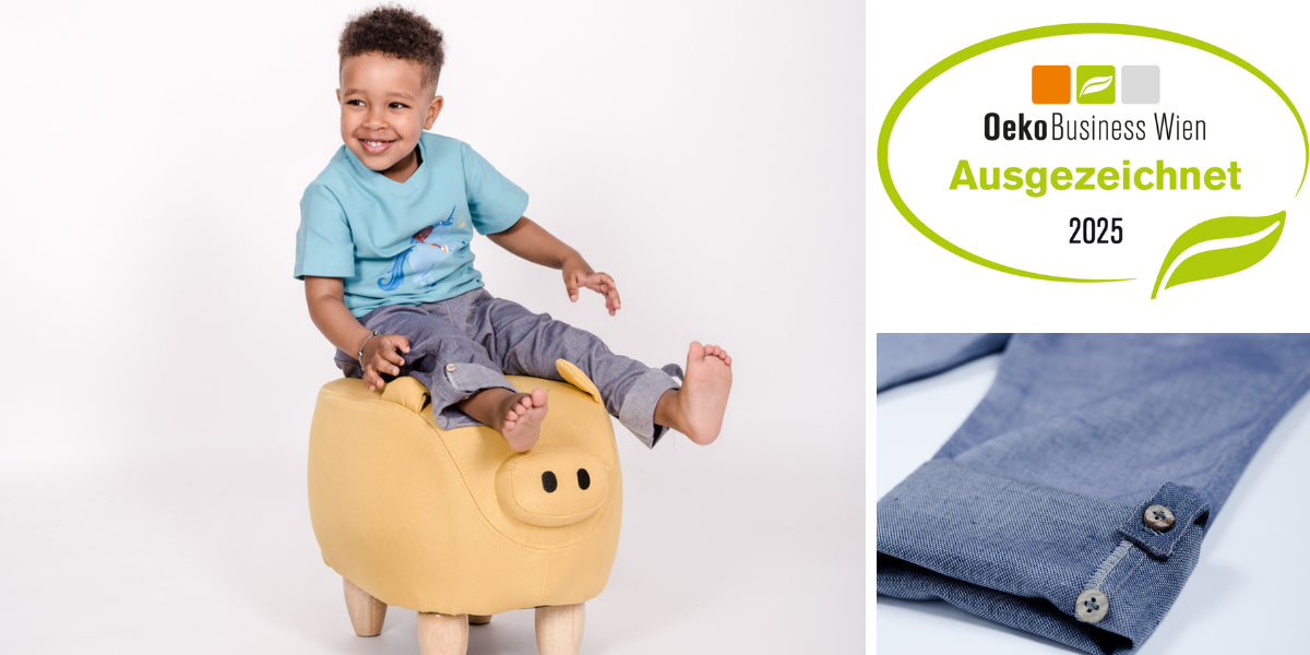 Kind mit pauakids Hosen und Oekobusiness Wien Auszeichnung